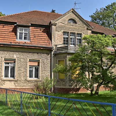 Das Foto zeigt das denkmalgeschützte Pfarrhaus in Radensleben. Die Sanierungsnotwendigkeit ist durch abgeplatzten Putz erkennbar.