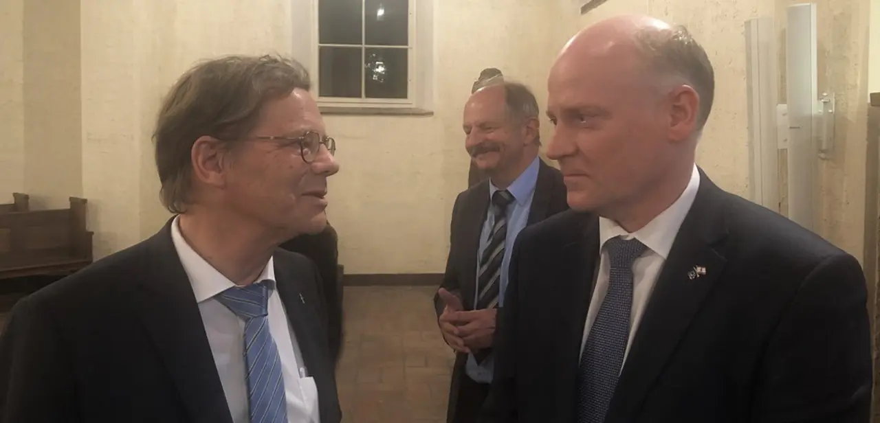 Staatssekretär Gerry Woop (rechts) mit Bischof Markus Dröge am 23. Oktober 2019 auf der Landessynoden-Eröffnung in Oranienburg, im Hintergrund links: Präses Sigrun Neuwerth, Foto: EKBO